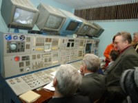 Some of the experts and specialists watch the control panel during the crew's final Soyuz examination and tests. After the test, these specialists questioned the crew about their every decision and action, before pronouncing them ready to fly.