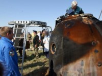 With the capsule safely on the ground, the ground team waste no time in getting the Cosmonauts into the open air.