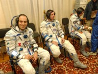 The crew wait to be picked up by the bus that is to take them to the launch pad. This will be their last journey on earth before reaching their destination 400kms up in outer space.